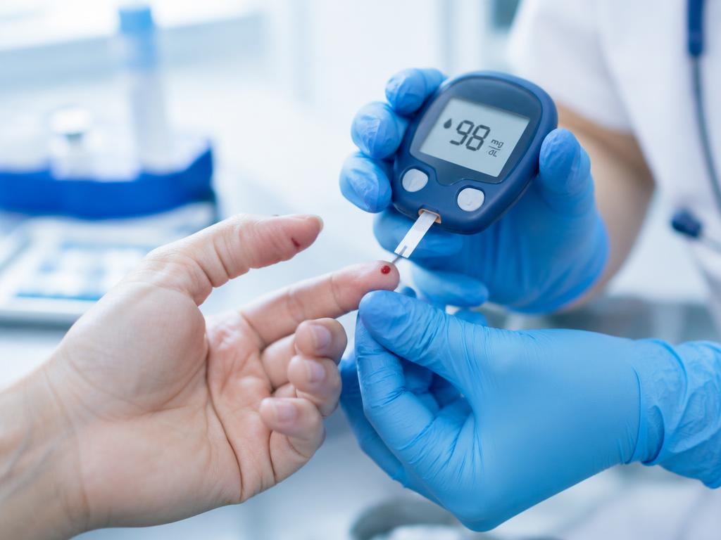 Finger-prick blood glucose test being taken with a glucometer